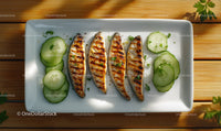 Grilled Fish Fillets with Fresh Cucumber Slices on White Plate