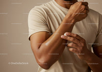 Close-Up of Man Applying Lotion to Arm for Skin Hydration