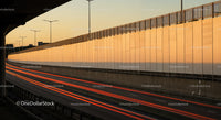 Sunset Scene of Urban Highway with Light Trails and City Skyline