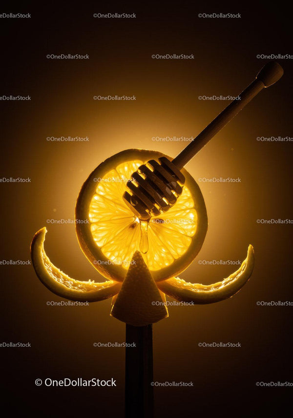 Honey Dripper with Lemon Slices on Warm Background