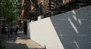 City Sidewalk with Pedestrians and Tree Shadows