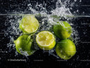 Fresh Green Limes Splash with Water Droplets in Dynamic Motion