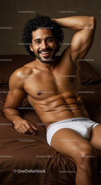 Confident man relaxing in white underwear on bed