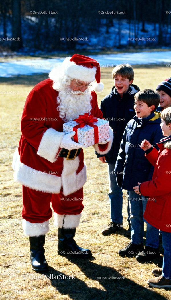Santa Claus Giving Gift to Excited Kids Outdoors