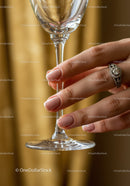Woman's Hand with Elegant Ring Holding Wine Glass
