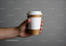 Hand Holding Disposable Coffee Cup with Sleeve