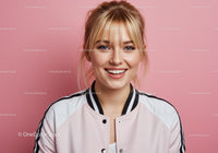 Happy Young Woman with Blonde Hair in Casual Jacket Against Pink Background