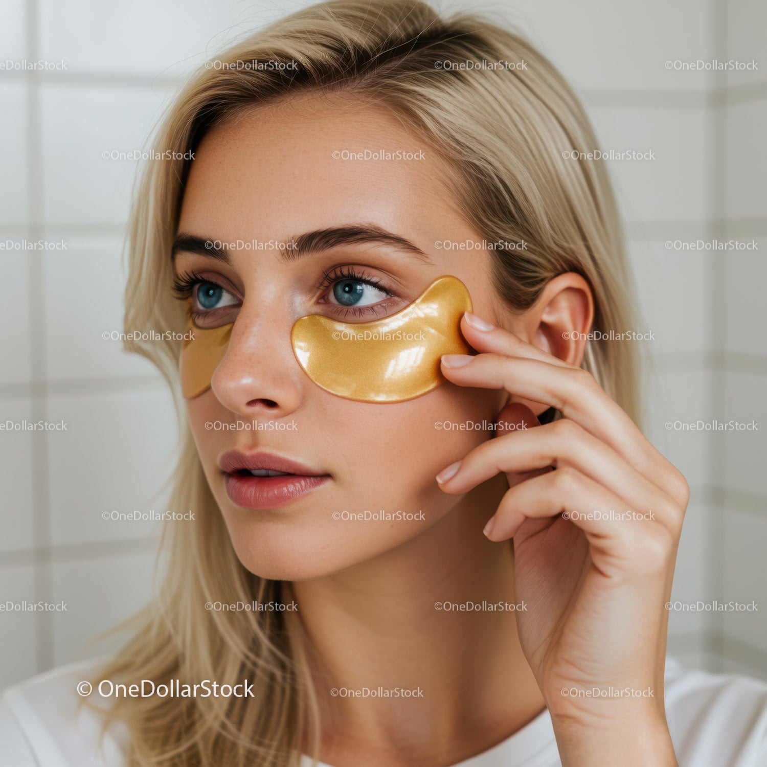 Young Woman Applying Gold Eye Patches for Skin Rejuvenation