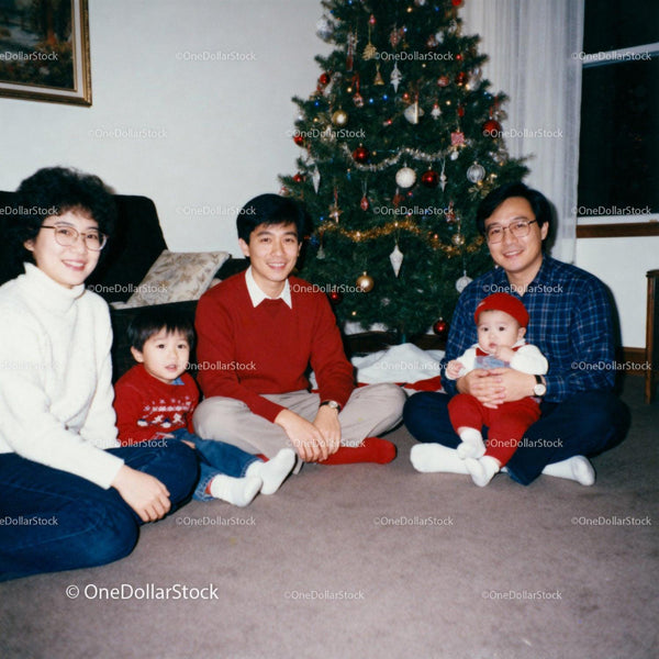 Family enjoying Christmas together by decorated tree