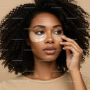 Woman with Curly Hair Applying Under Eye Patches for Skincare