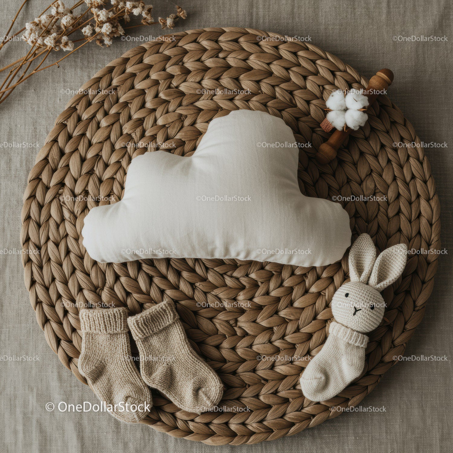Neutral baby essentials arranged on braided placemat