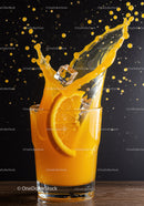 Fresh orange juice splash with ice cube and slice