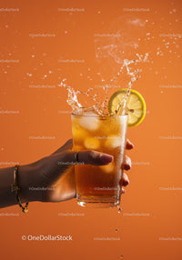 Refreshing iced tea splash with lemon slice on orange