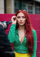 Vibrant Red Hair Woman in Green Tracksuit with Sunglasses in City
