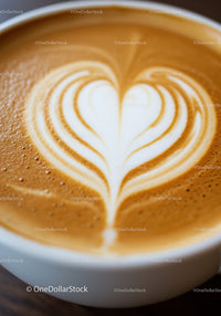 Close up of latte art heart in white coffee cup