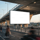 Urban blank billboard under concrete overpass at dusk