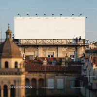 Two men standing near large blank billboard on rooftop