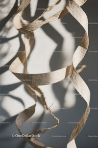 Close-up of White Plastic Ribbon Waste on Sandy Beach