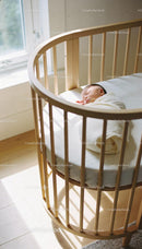 Peaceful newborn wrapped sleeping in wooden cradle