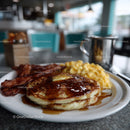 Stack of Fluffy Pancakes with Melted Butter and Syrup