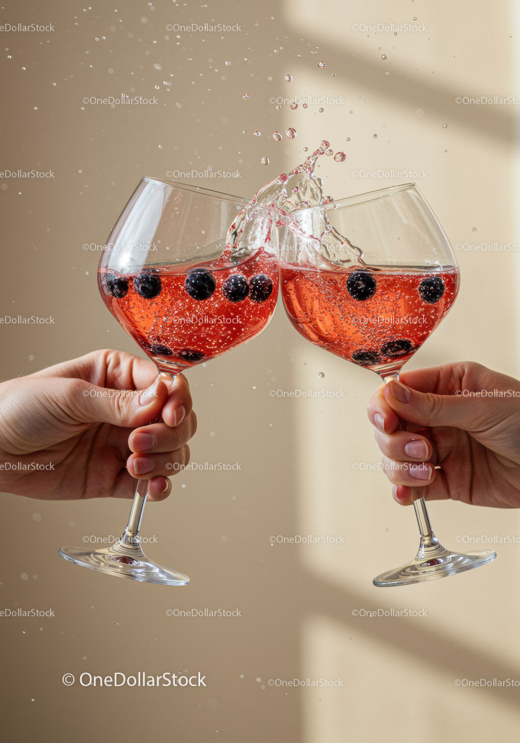 Two hands clinking glasses with sparkling berry drink