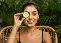 Woman Enjoying Facial Mask with Cucumber Eye Relaxation in Wellness Setting
