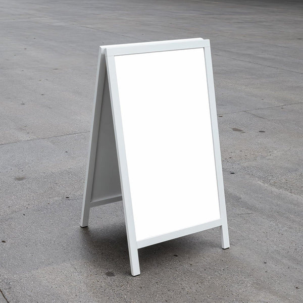 Blank white sandwich board on concrete outdoor surface JPG Mockup Image