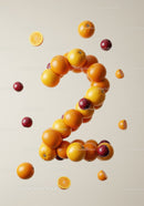 Fresh oranges and plums shaped into number two