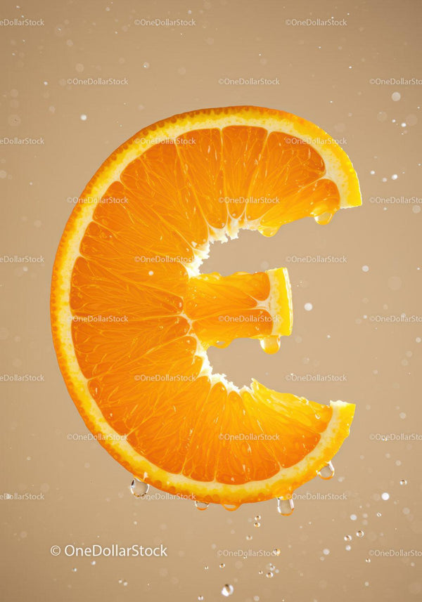 Fresh orange slice with Euro symbol shape and water drops
