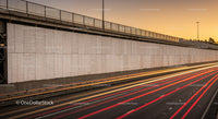 Moving Vehicle Light Trails on Highway During Sunset