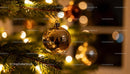 Golden Christmas Ornament Reflecting Warm Holiday Lights