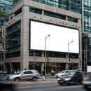 Urban street scene with large blank billboard on building