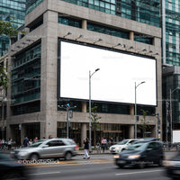 Urban street scene with large blank billboard on building