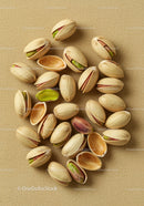 Close up of pistachio nuts on textured fabric background