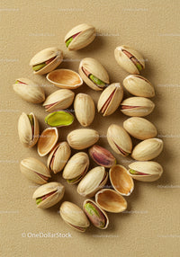 Close up of pistachio nuts on textured fabric background
