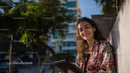 Young Woman Smiling with Tablet in an Urban Outdoors Setting