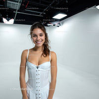 Bright Smiling Woman in White Corset Top in Studio Portrait