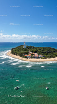 Scenic Coastal Island with Lighthouse and Boats Under Blue Sky