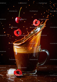 Fresh cherries splashing into coffee in glass mug