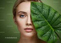 Portrait of a Beautiful Woman with Green Leaf and Water Droplets