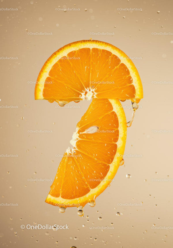 Fresh orange slices with water droplets on beige background
