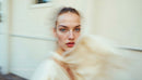 Stylish Woman in Motion Wearing Elegant Beige Outfit