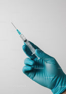 Close-up of Medical Syringe Held by Gloved Hand for Vaccination