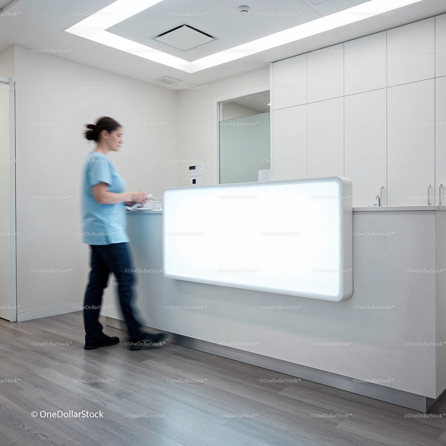Healthcare worker walking at modern clinic reception desk