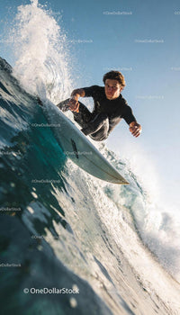 Focused surfer riding a powerful wave in clear ocean