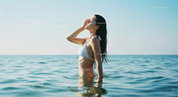 Young Woman Relaxing in Blue Ocean During Sunny Day