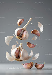 Fresh garlic cloves and bulb with peeling skin floating