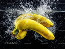 Fresh Yellow Bananas Splashing into Water with Dynamic Motion