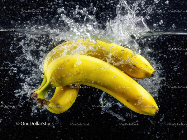 Fresh Yellow Bananas Splashing into Water with Dynamic Motion