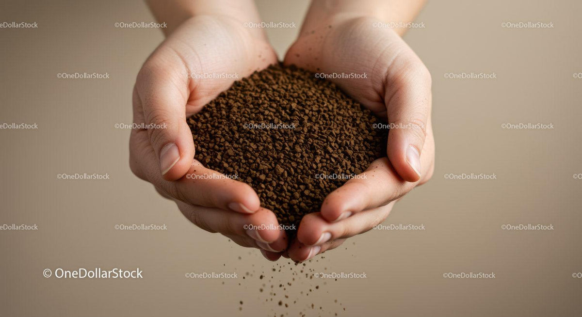 Hands gently holding coffee granules pouring down